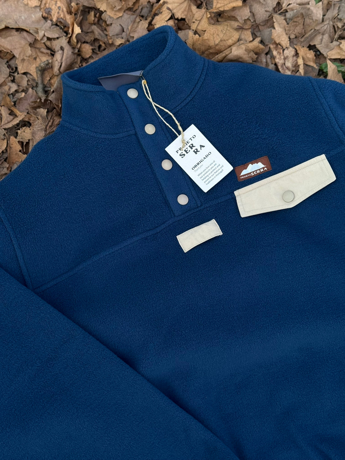 Produzida em malha polar azul marinho 100% Polyester reciclado com aplique no peito onde podes colocar/prender aquilo que o teu coração pede.  